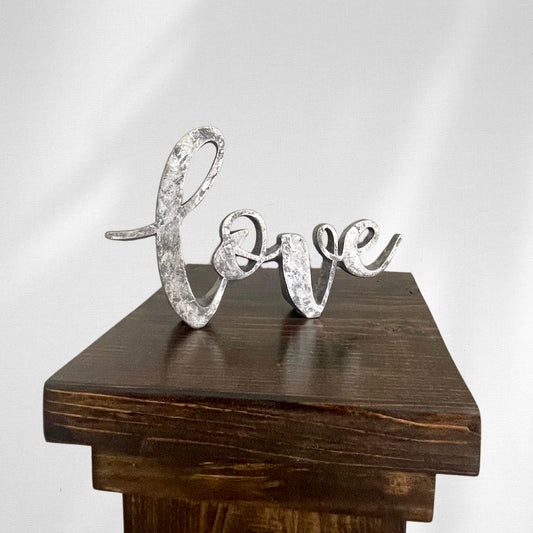 Silver table top decor love spelt in cursive for rent - Picture Perfect Rentals