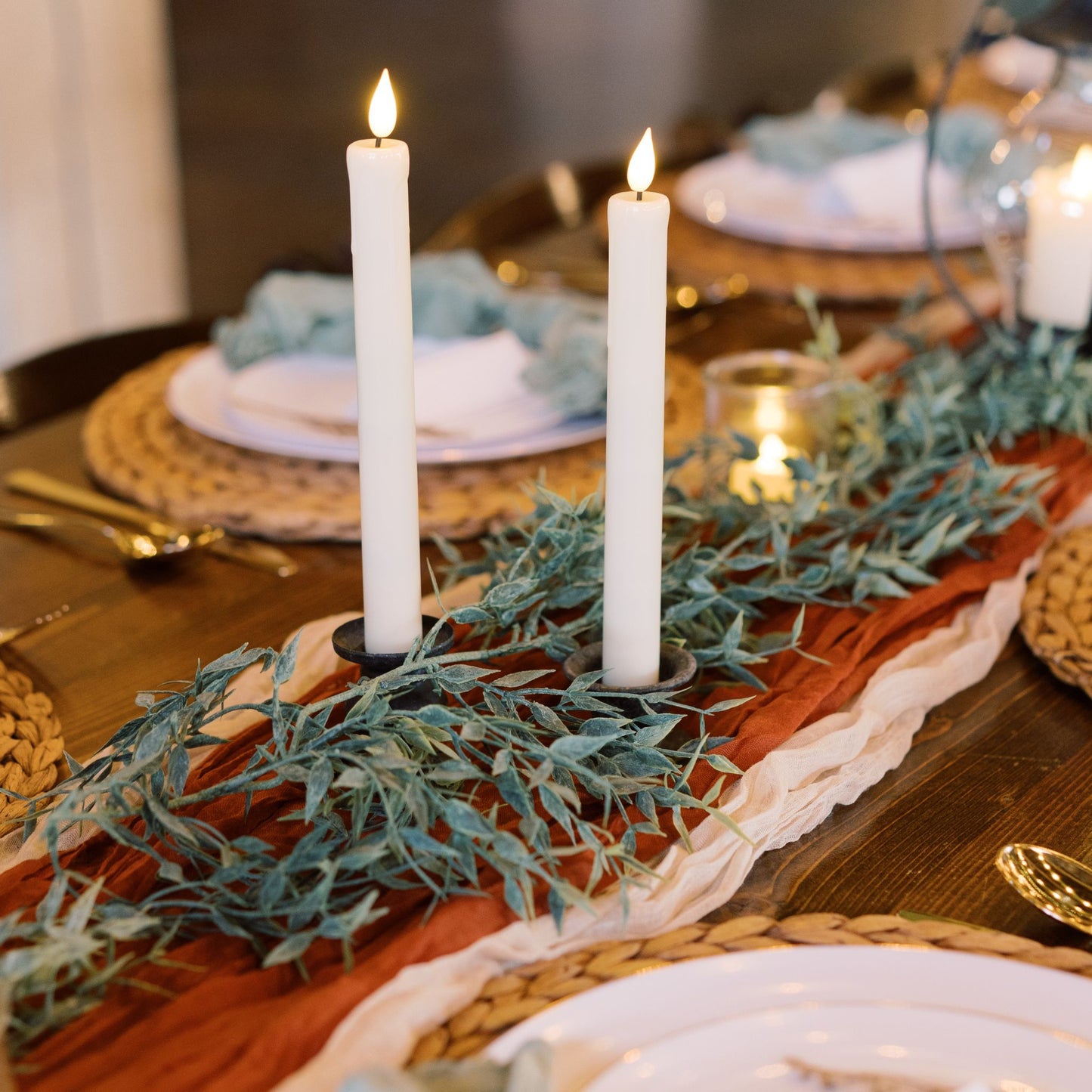 Italian ruscus greenery garland, cheesecloth table runners & flameless tapered candles for rent - Picture Perfect Rentals