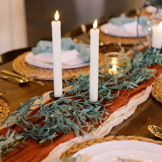 Italian ruscus greenery garland, cheesecloth table runners & flameless tapered candles for rent - Picture Perfect Rentals