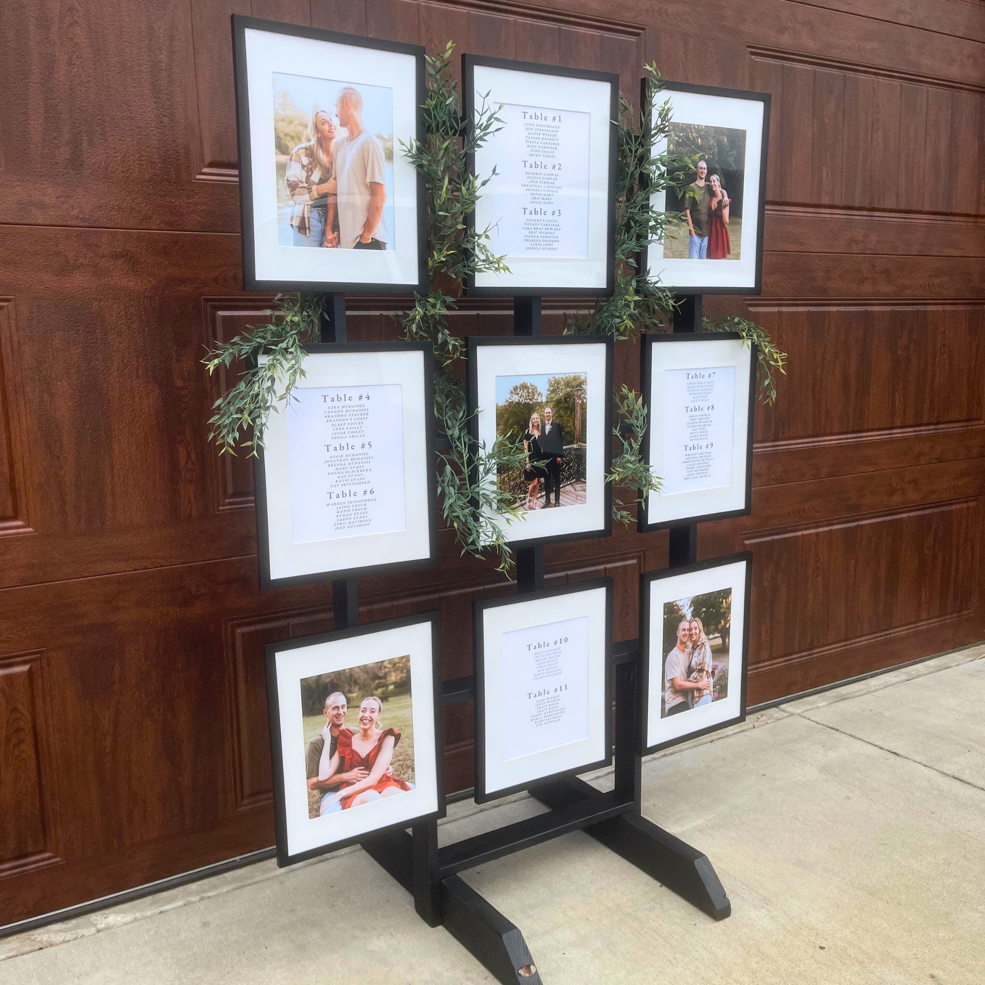 Picture Frame Holder Stand featuring 5 photos and 4 different seating chart table layouts adorned with italian ruscus woven through the stand - Picture Perfect Rentals