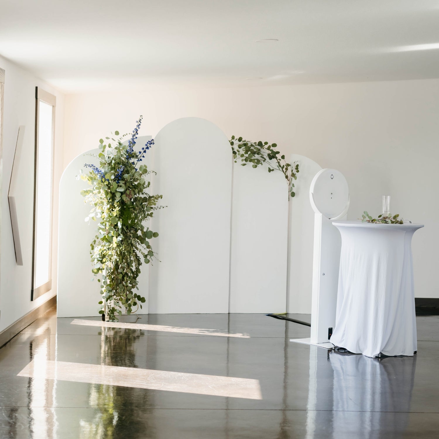 White arched backdrops with greenery florals for wedding photo booth - Picture Perfect Rentals Wichita, KS event rental company