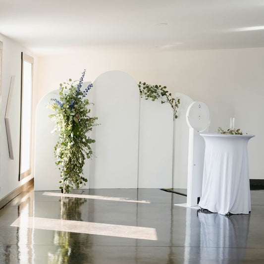 White arched backdrops with greenery florals for wedding photo booth - Picture Perfect Rentals Wichita, KS event rental company