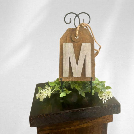 Black metal easel holding up an M sign - Picture Perfect Rentals
