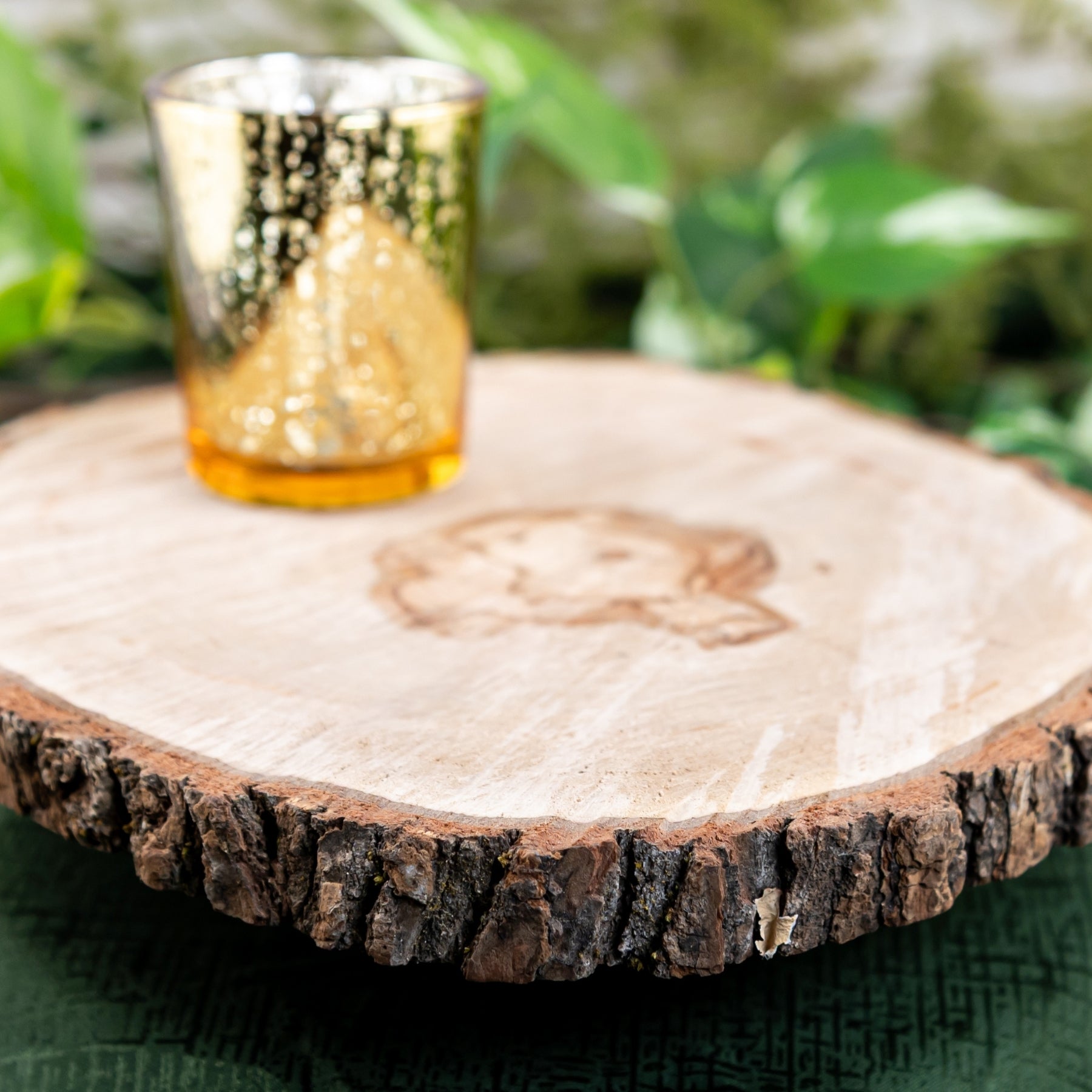 Wood Round on a green cloth with candle holder close up angle, wedding rentals in Wichita, Kansas - Picture Perfect Rentals 